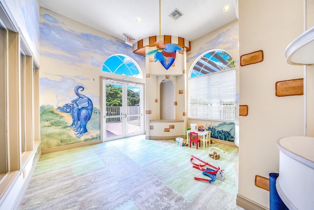 playroom featuring baseboards, visible vents, and a wealth of natural light