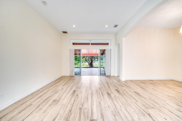spare room featuring baseboards, wood finished floors, visible vents, and recessed lighting