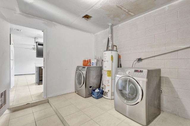 washroom featuring laundry area, visible vents, water heater, concrete block wall, and washer and dryer