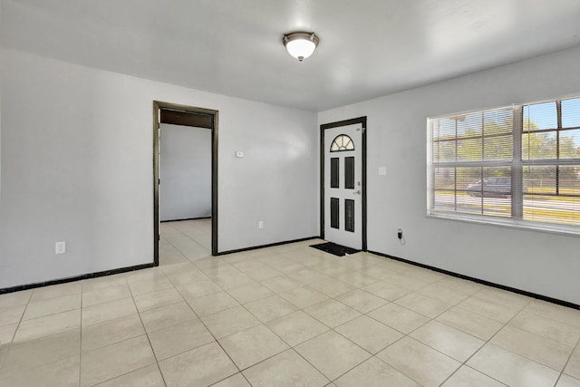 spare room featuring baseboards