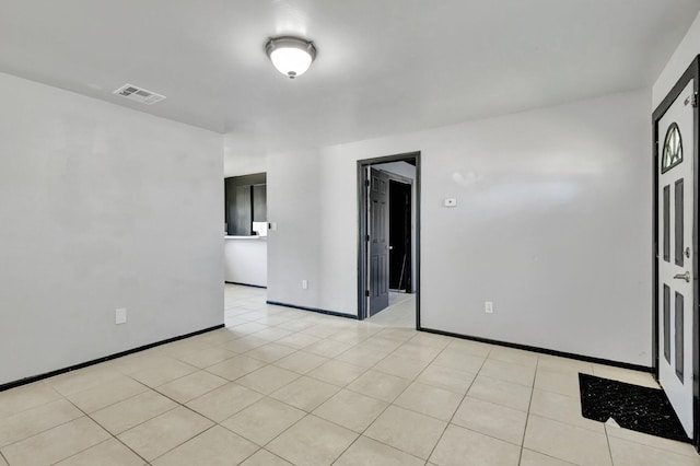 unfurnished room with visible vents and baseboards