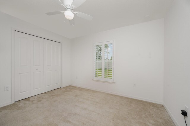 1544 Summit Rd SE, Palm Bay, FL 32909 - unfurnished bedroom featuring baseboards, a ceiling fan, a closet, and carpet flooring