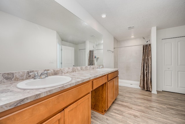 1544 Summit Rd SE, Palm Bay, FL 32909 - full bath with wood finished floors, a shower stall, double vanity, and a sink