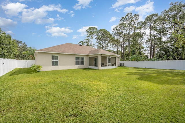 1544 Summit Rd SE, Palm Bay, FL 32909 - back of property with stucco siding, a yard, a fenced backyard, and a sunroom