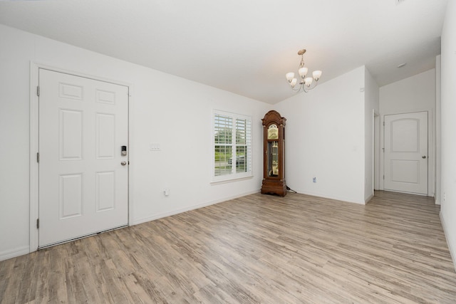 1544 Summit Rd SE, Palm Bay, FL 32909 - interior space with a chandelier, baseboards, light wood-style floors, and lofted ceiling
