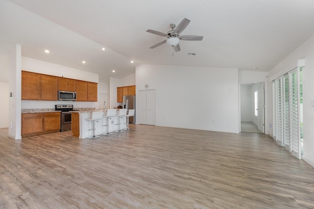 1544 Summit Rd SE, Palm Bay, FL 32909 - unfurnished living room with recessed lighting, ceiling fan, light wood-style floors, and vaulted ceiling