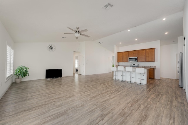 1544 Summit Rd SE, Palm Bay, FL 32909 - unfurnished living room featuring recessed lighting, vaulted ceiling, light wood-type flooring, visible vents, and a ceiling fan