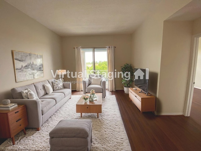 living area with baseboards and wood finished floors