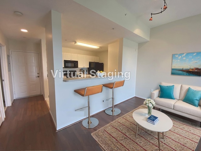 living room featuring baseboards and dark wood-style flooring