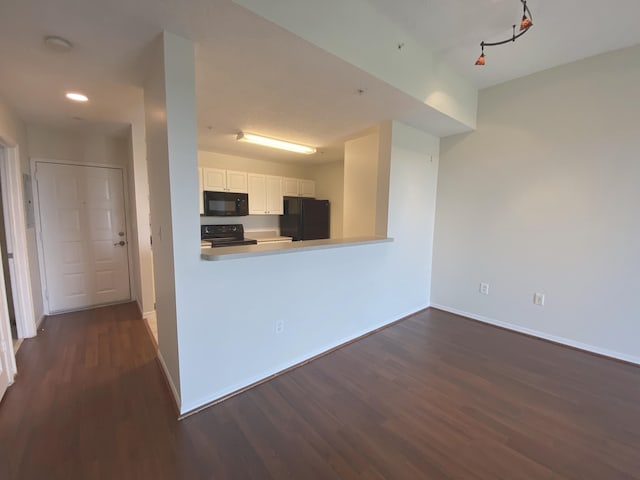 kitchen with dark wood-style flooring, recessed lighting, baseboards, white cabinetry, and black appliances