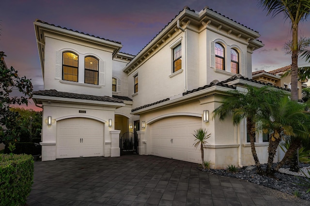 16202 Cabernet Dr, Delray Beach, FL 33446 - mediterranean / spanish house with a gate, an attached garage, and stucco siding