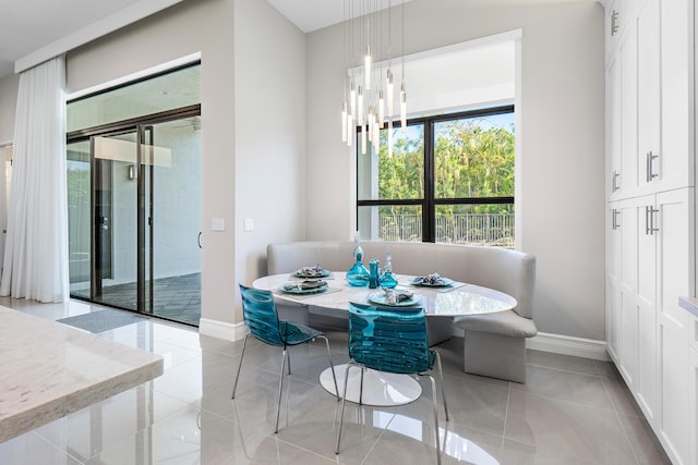 16202 Cabernet Dr, Delray Beach, FL 33446 - dining space with a chandelier, baseboards, breakfast area, and light tile patterned floors