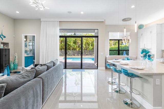 16202 Cabernet Dr, Delray Beach, FL 33446 - living room featuring light tile patterned flooring, baseboards, a notable chandelier, and recessed lighting