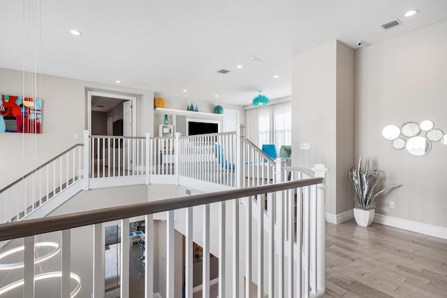 16202 Cabernet Dr, Delray Beach, FL 33446 - corridor featuring wood finished floors, an upstairs landing, baseboards, visible vents, and recessed lighting