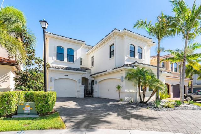 16202 Cabernet Dr, Delray Beach, FL 33446 - mediterranean / spanish-style home with stucco siding, a tiled roof, and a garage