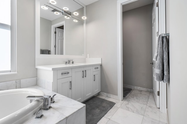 16202 Cabernet Dr, Delray Beach, FL 33446 - bathroom featuring marble finish floor, visible vents, vanity, baseboards, and a garden tub