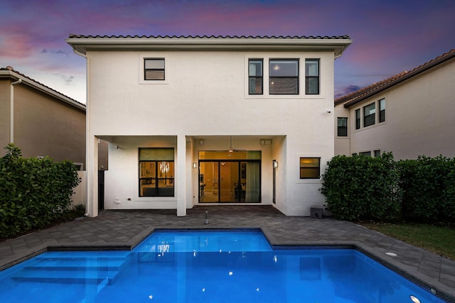 16202 Cabernet Dr, Delray Beach, FL 33446 - rear view of house featuring a patio area, a fenced in pool, and stucco siding