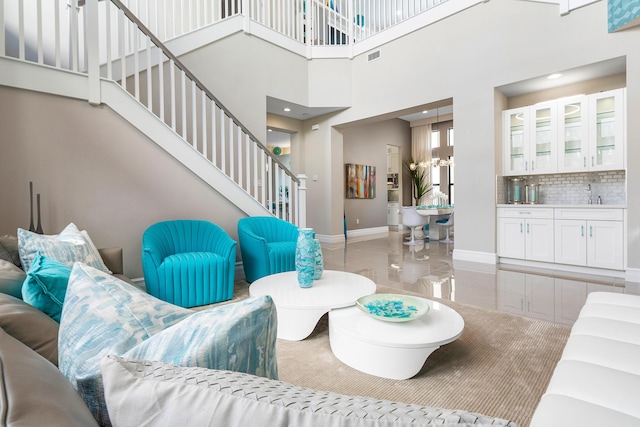 16202 Cabernet Dr, Delray Beach, FL 33446 - living room with baseboards, visible vents, stairs, and a high ceiling