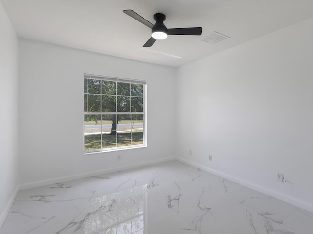 1201 SW Paar Dr, Port Saint Lucie, FL 34953 - empty room with marble finish floor, visible vents, baseboards, and a ceiling fan