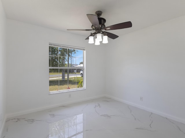 1201 SW Paar Dr, Port Saint Lucie, FL 34953 - empty room featuring baseboards, marble finish floor, and a ceiling fan