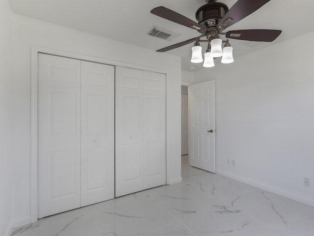 1201 SW Paar Dr, Port Saint Lucie, FL 34953 - unfurnished bedroom with a closet, marble finish floor, visible vents, a ceiling fan, and baseboards