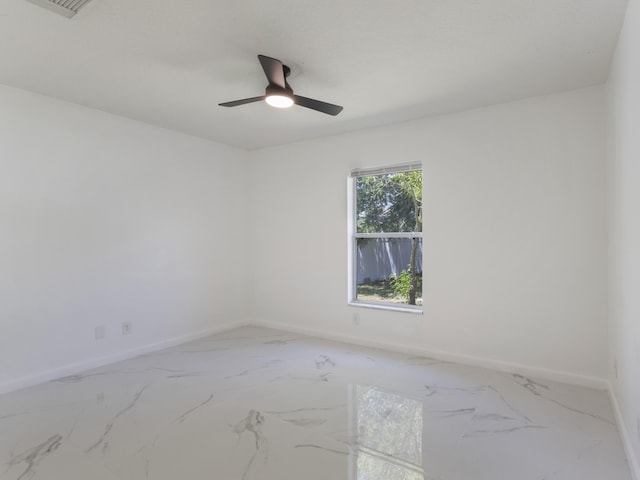 1201 SW Paar Dr, Port Saint Lucie, FL 34953 - empty room featuring baseboards, a ceiling fan, and marble finish floor