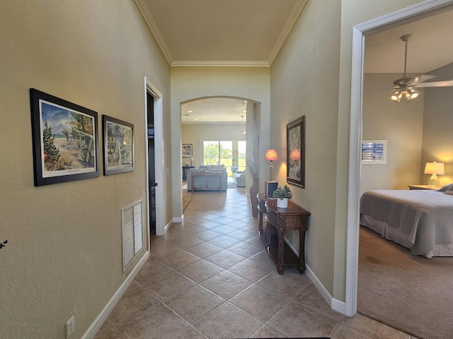 411 NW Stratford Ln, Port Saint Lucie, FL 34983 - hallway featuring arched walkways, ornamental molding, tile patterned floors, and baseboards