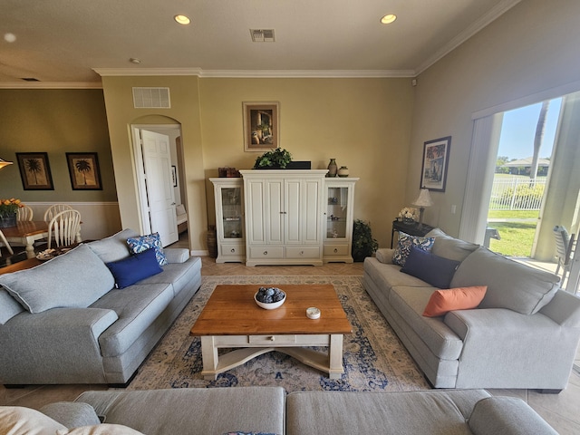 411 NW Stratford Ln, Port Saint Lucie, FL 34983 - living room featuring light tile patterned floors, ornamental molding, arched walkways, recessed lighting, and baseboards