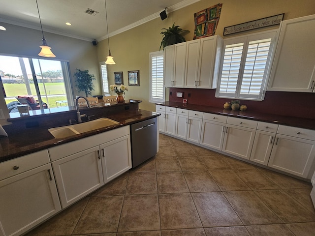 411 NW Stratford Ln, Port Saint Lucie, FL 34983 - kitchen with dishwasher, a sink, crown molding, healthy amount of natural light, and dark countertops