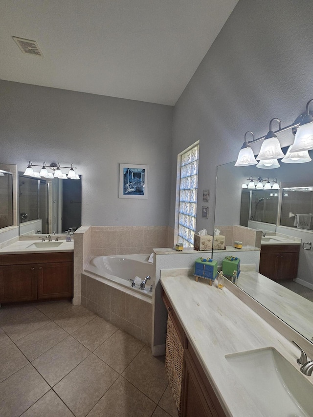 411 NW Stratford Ln, Port Saint Lucie, FL 34983 - bathroom with a bath, a stall shower, tile patterned floors, and two vanities