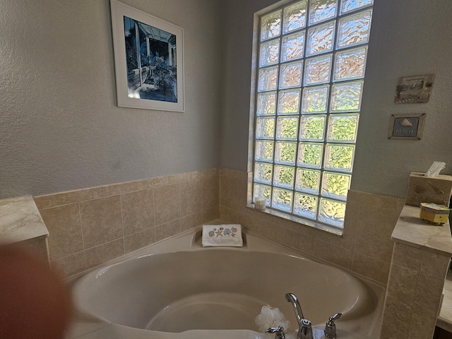 411 NW Stratford Ln, Port Saint Lucie, FL 34983 - full bathroom featuring a garden tub and a textured wall
