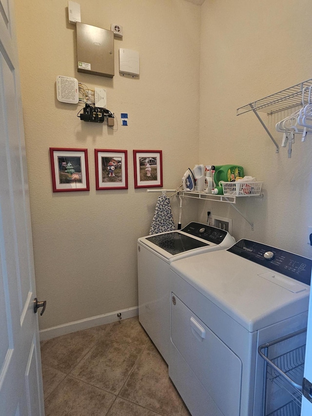 411 NW Stratford Ln, Port Saint Lucie, FL 34983 - laundry area with washing machine and clothes dryer, baseboards, and light tile patterned floors