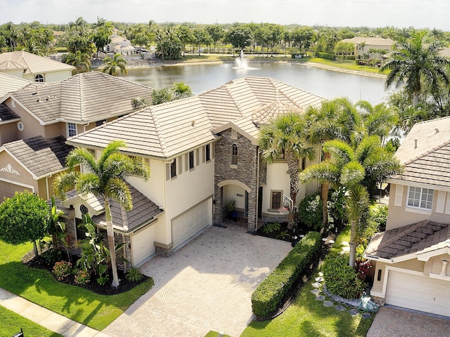 drone / aerial view featuring a residential view and a water view