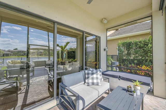 sunroom featuring a water view and plenty of natural light