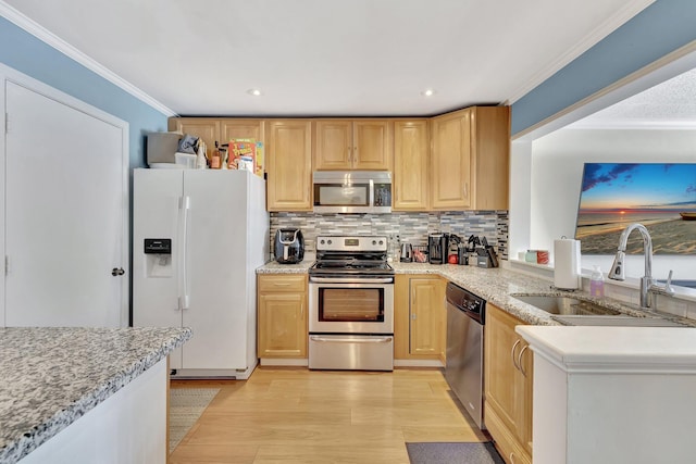 2190 Discovery Cir W, Deerfield Beach, FL 33442 - kitchen with light wood-type flooring, light brown cabinets, crown molding, stainless steel appliances, and a sink