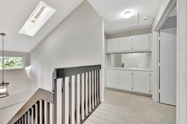 2190 Discovery Cir W, Deerfield Beach, FL 33442 - corridor with light carpet, vaulted ceiling with skylight, and a notable chandelier
