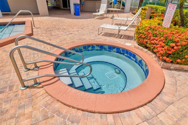 2190 Discovery Cir W, Deerfield Beach, FL 33442 - view of pool with a patio area and a hot tub