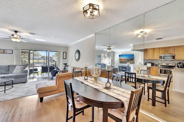 2190 Discovery Cir W, Deerfield Beach, FL 33442 - dining space featuring a ceiling fan, light wood-style floors, and a textured ceiling