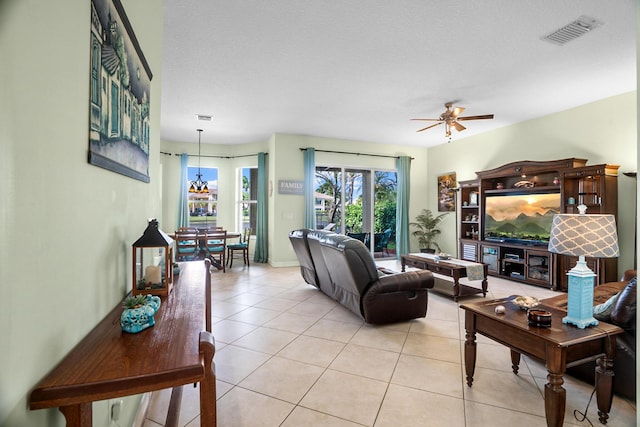 8207 Venosa Haven Ter, Boynton Beach, FL 33473 - living room featuring baseboards, ceiling fan with notable chandelier, visible vents, and light tile patterned floors