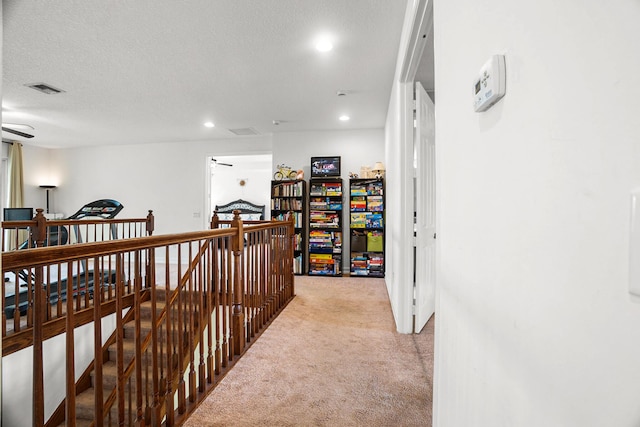 8207 Venosa Haven Ter, Boynton Beach, FL 33473 - corridor with a textured ceiling, an upstairs landing, light carpet, visible vents, and recessed lighting