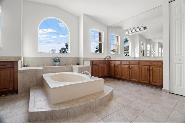 8207 Venosa Haven Ter, Boynton Beach, FL 33473 - full bathroom featuring a bath, vaulted ceiling, tile patterned floors, and vanity