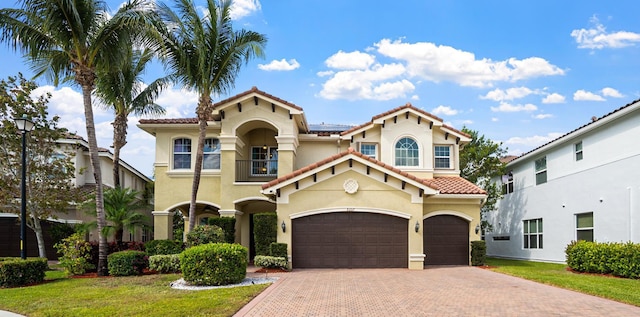 8207 Venosa Haven Ter, Boynton Beach, FL 33473 - mediterranean / spanish-style home with a tiled roof, an attached garage, a balcony, stucco siding, and decorative driveway