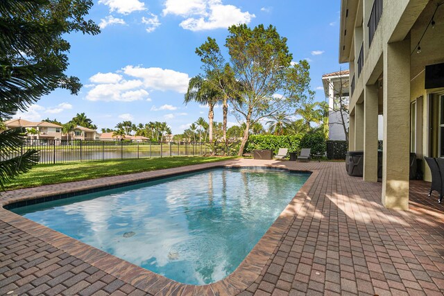 8207 Venosa Haven Ter, Boynton Beach, FL 33473 - view of pool with a patio area, a fenced backyard, a fenced in pool, and a water view