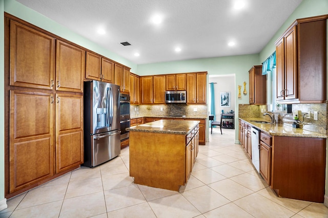 8207 Venosa Haven Ter, Boynton Beach, FL 33473 - kitchen featuring a sink, dark stone counters, visible vents, a kitchen island, and appliances with stainless steel finishes