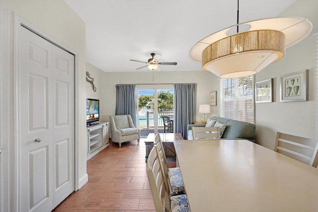 dining room with ceiling fan and wood finished floors
