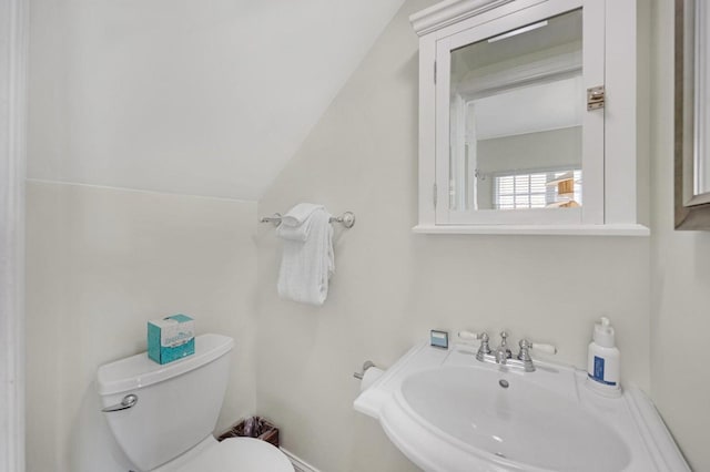 half bath featuring toilet and a sink
