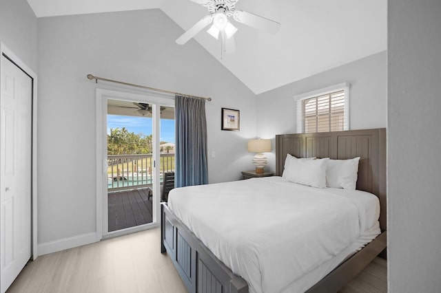 bedroom featuring a closet, ceiling fan, access to outside, high vaulted ceiling, and baseboards