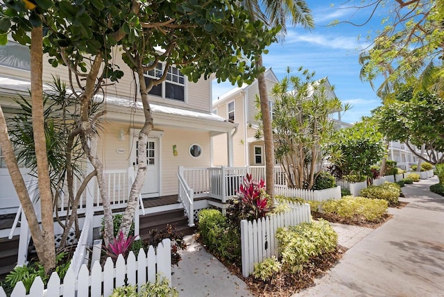 view of front facade featuring a porch and fence