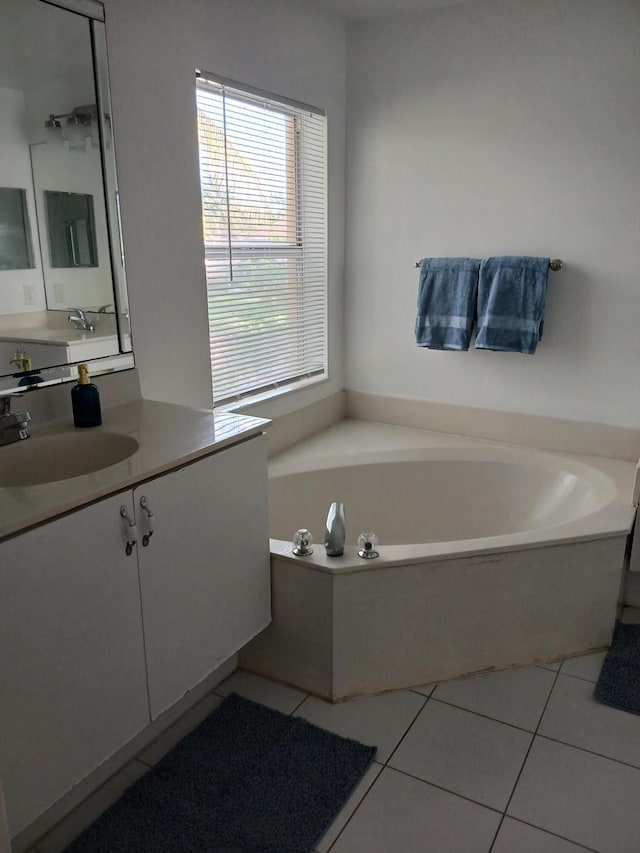 312 River Bluff Ln, Royal Palm Beach, FL 33411 - bathroom with vanity, a garden tub, and tile patterned floors