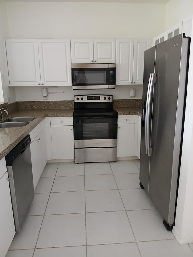 312 River Bluff Ln, Royal Palm Beach, FL 33411 - kitchen featuring stainless steel appliances, white cabinets, and light tile patterned floors